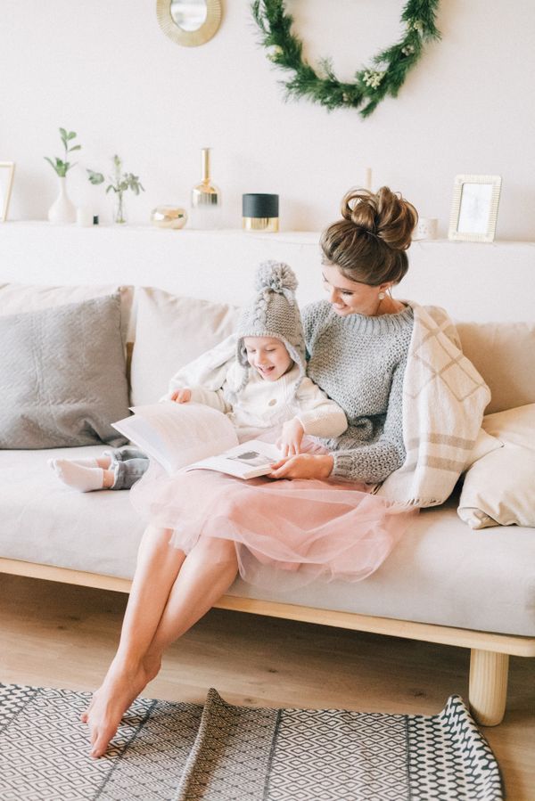 A parent and child reading together at home